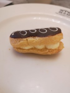 Photograph close up of the mini chocolate eclair on a white plate