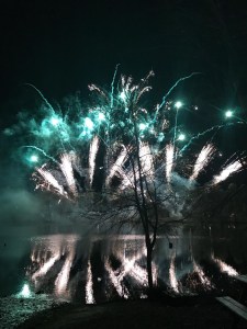 Stunning turquoise and white fireworks reflected in the lake. 