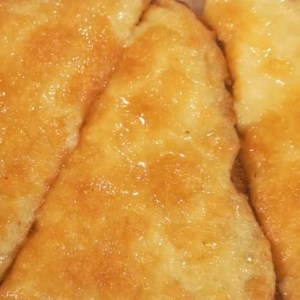 A close up photo of golden melted cheese. 