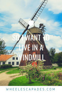A bright colourful image of a windmill on green grass with a tree and blue sky. The title text So I Want To Live In A Windmill is placed over. This is an image to pin for my accessible housing post. 