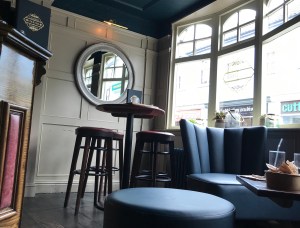 In the bottom right hand corner is the low coffee table we were given. Behind are some bar stools at a high table. There is a large window in the background 