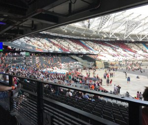A photo taken looking towards the left where you can see the curve of the stadium and seats filling up