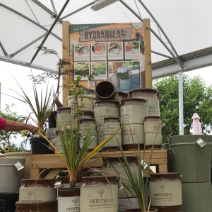 In the outside shop area there is still a roof for shelter. A stack of rustic pots for planting are on display