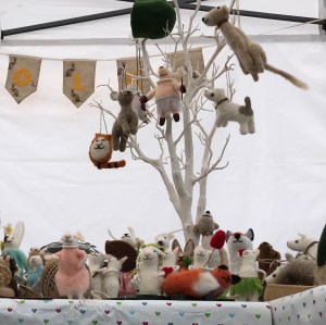 A craft stall with miniature felted animals 