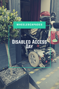 An image to pin. A photo of me in my wheelchair driving up a portable ramp into a restaurant. Title text, Disabled Access Day is placed over. 