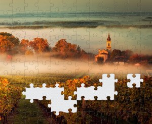 A screenshot of my puzzle app. A misty scene with a church in the distance. Some of the jigsaw pieces are missing. 