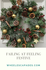 An image to pin. Failing at Feeling Festive title text is in grey on a cream background at the bottom. The top two thirds of the image is the photo of my wreath on the white door. 